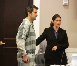 Michael Slager stands as defense attorney Cameron Blazer guides him toward the podium to speak in circuit court for the first time at the Charleston County Court House September 11, 2015 in Charleston, South Carolina. (Credit: Leroy Burnell - Pool/Getty Images)