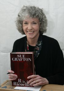 Author Sue Grafton poses with a copy of her book "R is for Ricochet" at the 10th annual Los Angeles Times Festival of Books at UCLA on April 23, 2005 in Los Angeles. (Credit: Michael Buckner/Getty Images)