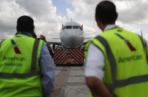 Employees watch as American Airlines Flight 903 prepares for takeoff, becoming the first commercial flight from Miami to Cuba in 55-years on Sept. 7, 2016. (Credit: Joe Raedle / Getty Images)