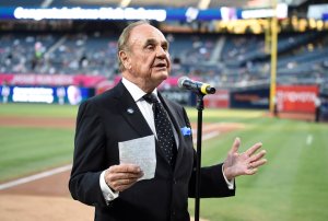 Dick Enberg talks to the crowd during a ceremony held before a baseball game between the San Diego Padres and the Los Angeles Dodgers at PETCO Park on September 29, 2016 in San Diego, California. The Padres held the pre-game ceremony to honor Enberg's last home game as the team's primary play-by-play man for television broadcasts. (Photo by Denis Poroy/Getty Images)