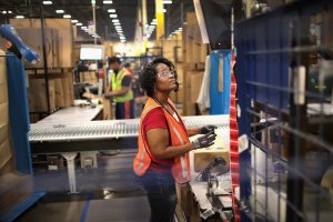 Workers pack and ship customer orders at the 750,000-square-foot Amazon fulfillment center in Romeoville, Illinois, on Aug. 1, 2017. (Credit: Scott Olson / Getty Images)