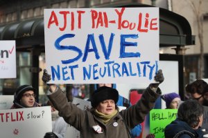 Demonstrators, supporting net neutrality, protest a plan by the Federal Communications Commission (FCC) to repeal restrictions on internet service providers during a protest outside a Verizon store in Chicago on Dec. 7, 2017. (Credit: Scott Olson / Getty Images)