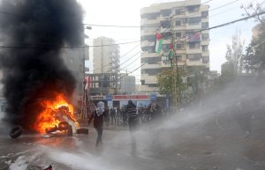 Lebanese security forces use a water hose to disperse protestors during a demonstration outside the U.S. embassy in Awkar, on the outskirts of the Lebanese capital Beirut, on Dec. 10, 2017. (Credit: Anwar Amro / AFP / Getty Images)
