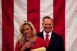 Republican Senatorial candidate Roy Moore smiles as his wife Kayla speaks at a rally in Midland, Alabama, on December 11, 2017. (Credit: JIM WATSON/AFP/Getty Images)