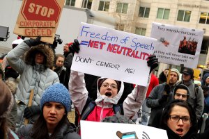 Demonstrators rally outside the Federal Communication Commission building to protest against the end of net neutrality rules on December 14, 2017 in Washington, DC. (Credit: Chip Somodevilla/Getty Images)