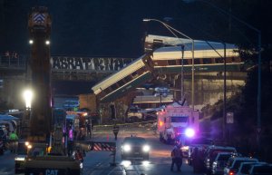 Work crews prepare to clear southbound I-5 lanes at the scene of an Amtrak train derailment on December 18, 2017 in DuPont, Washington. At least six people were killed when several train cars plunged from the bridge. (Credit: Stephen Brashear/Getty Images)