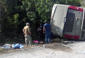 Mexican police officers and paramedics work in the scene of a road accident, where a bus driving tourists to Chacchoben archaeological zone overturned between El Cafetal and Mahahual, in Quintana Roo state, Mexico on Dec. 19, 2017. (Credit: MANUEL JESUS ORTEGA CANCHE/AFP/Getty Images)