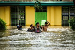 Residents evacuate to a safer place in Kabacan, North Cotabato, on the southern island of Mindanao on Dec. 23, 2017, after Tropical Storm Tembin dumped torrential rains across the island. (Credit: Ferdinandh Cabrera/AFP/Getty Images)