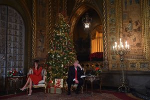 President Donald Trump and First Lady Melania Trump participate in NORAD Santa Tracker phone calls at the Mar-a-Lago resort in Palm Beach, Florida, on Dec. 24, 2017. (Credit: Nicholas Kamm / AFP / Getty Images)