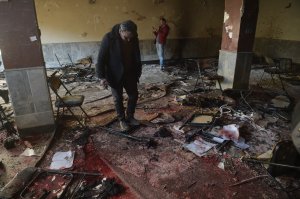 Afghan residents inspect the site of a bomb attack on a Shiite cultural center in Kabul on Dec. 28, 2017. (Credit: Shah Marai / AFP / Getty Images)