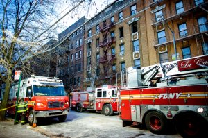 A fire Department of New York personnel works on the scene of an apartment fire is in the Bronx borough of New York City is seen on Dec. 29, 2017. (Credit: Kena Betancur AFP/Getty Images)