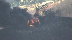 A structure burns in the Liberty Fire near Murrieta on Dec. 7, 2017. (Credit: KTLA)