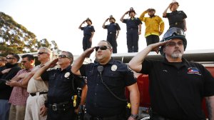 Emergency responders salute as a procession is held for fallen firefighter Cory Iverson in the Fillmore area. (Credit: Al Seib/Los Angeles Times)