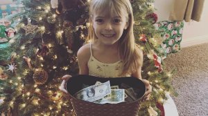 Faye Segraves is seen in a family photo with the money she collected for the Wildland Firefighter Foundation. 