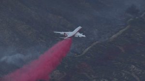 A 747 SuperTanker drops retardant on the Liberty Fire near Murrieta on Dec. 7, 2017. (Credit: KTLA)