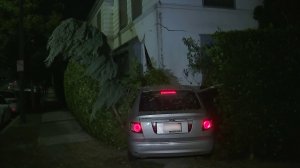 A car crashed into a building in Brentwood on Dec. 3, 2017. (Credit: KTLA)