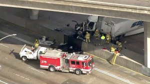 A big rig is seen after it fell onto the 5 Freeway in Pacoima from an overpass on Jan. 9, 2018. (Credit: KTLA)