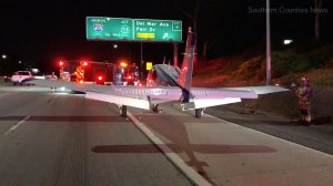 A small plane landed on the 55 Freeway in Costa Mesa on Jan. 28, 2018. (Credit: Southern Counties News)