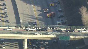People stop on an overpass to survey the damage below on the 210 Freeway. (Credit: KTLA)