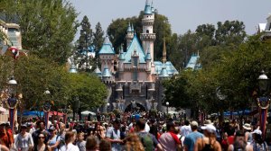Crowds walk down Main Street in front of Sleeping Beauty Castle at Disneyland in Anaheim in June 2017. (Credit: Gary Coronado / Los Angeles Times)