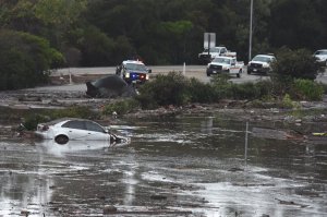 A car was stuck in the flooded 101 Freeway at the Olive Mill Road overpass in Montecito on Jan. 9, 2018. (Credit: Mike Eliason / Santa Barbara County Fire Department)