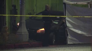 The body was next to a car that had crashed into a utility pole. (Credit: KTLA)