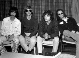 American psychedelic rock band, The Doors during a press conference at Heathrow Airport, London (left to right); drummer John Densmore, keyboard player Ray Mansarek, vocalist Jim Morrison (1943 - 1971) and guitarist Robby Krieger. (Credit: Central Press/Getty Images)