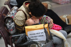 A family from El Salvador embraces while awaiting a bus from the border into the interior of the United States on Jan. 4, 2017 in McAllen, Texas. (Credit: John Moore / Getty Images)