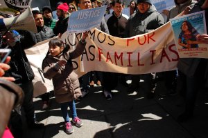 A 6-year-old girl from El Salvador holds a placard during a rally around Trump Tower  in New York in support of immigrants workers on April 08, 2017. (Credit: Kena Betancur / AFP / Getty Images)