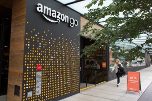 A woman walks past the Amazon Go grocery store at the Amazon corporate headquarters on June 16, 2017 in Seattle, Washington. (Credit: David Ryder/Getty Images)