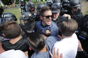 White nationalist Richard Spencer, center, and his supporters clash with Virginia State Police in Emancipation Park after the "Unite the Right" rally was declared an unlawful gathering Aug. 12, 2017 in Charlottesville, Virginia. (Credit: Chip Somodevilla/Getty Images)