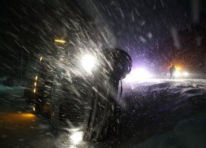 A tractor trailer lays on its side after running off the road in Georgetown, Delaware, during a snow storm on Jan. 4, 2018. (Credit: Mark Wilson / Getty Images)