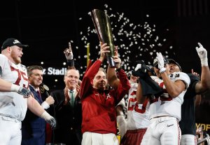 Head coach Nick Saban of the Alabama Crimson Tide holds the trophy while celebrating with his team after defeating the Georgia Bulldogs in overtime to win the CFP National Championship presented by AT&T at Mercedes-Benz Stadium on January 8, 2018 in Atlanta, Georgia. (Credit: Jamie Squire/Getty Images)