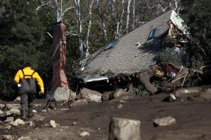 A home that was destroyed by a mudslide sits on its side in a field of debris on January 11, 2018 in Montecito, California. (Credit: Justin Sullivan/Getty Images)