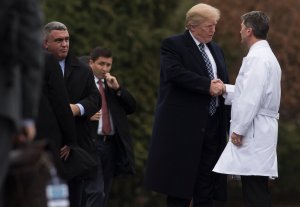 President Donald Trump shakes hands with White House Physician Rear Admiral Dr. Ronny Jackson following his annual physical at Walter Reed National Military Medical Center in Bethesda, Maryland, Jan. 12, 2018. (Credit: Saul Loeb / AFP / Getty Images)