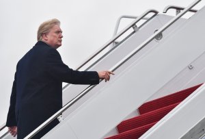 President Donald Trump boards Air Force One at Joint Base Andrews, Maryland on January 12, 2018, for a weekend trip to Mar-a-Lago. (Credit: NICHOLAS KAMM/AFP/Getty Images)