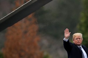 Donald Trump waves to journalists as he boards Marine One on departure from Walter Reed National Military Medical Center following his annual physical examination on Jan. 12, 2018 in Bethesda, Maryland. (Credit: Chip Somodevilla/Getty Images)