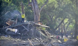 Search and rescue workers look through the debris of a demolished neighborhood in Montecito on Jan. 12, 2018. (Credit: FREDERIC J. BROWN/AFP/Getty Images)