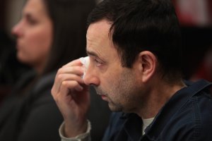 Larry Nassar wipes a tear as he listens to Carrie Hogan deliver a victim impact statement at his sentencing hearing on Jan. 17, 2018, in Lansing, Michigan. (Credit: Scott Olson / Getty Images)