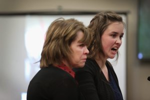 With her mother by her side, Helena Weick delivers a victim impact statement at the sentencing hearing for Larry Nassar, who has been accused of molesting more than 100 girls while he was a physician for USA Gymnastics and Michigan State University, on Jan. 17, 2018, in Lansing, Michigan. (Credit: Scott Olson / Getty Images)