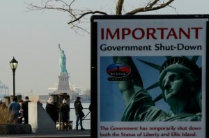 A placard is seen at the entrance of the Liberty State ferry terminal as people look on in New York City on Jan. 21, 2018. (Credit: Eduardo Munoz Alvarez / Getty Images)