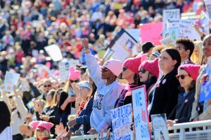 Attendees listen to speakers during the Women's March "Power to the Polls" voter registration tour launch at Sam Boyd Stadium in Las Vegas on Jan. 21, 2018. (Credit: Sam Morris / Getty Images)