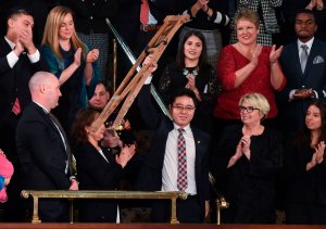 North Korean defector Ji Seong-ho raises his crutches as President Donald Trump delivers the State of the Union address at the U.S. Capitol in Washington, D.C. on Jan. 30, 2018. (Credit: SAUL LOEB/AFP/Getty Images)