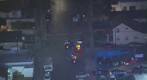 A van remains at the scene of a hit-and-run crash surrounded by LAPD vehicles in South Los Angeles on Jan. 12, 2018. (Credit: KTLA)
