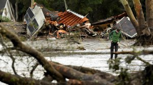 A man walks by destruction along Olive Mill Road in Montecito on Jan. 9, 2018. (Credit: Wally Skalij / Los Angeles Times)