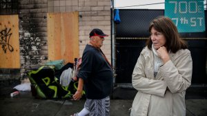 Lisa Rich stands outside her property on East 7th Street after a blaze engulfed a tent on skid row and spread to her warehouse in December 2017. (Credit: Jay L. Clendenin / Los Angeles Times)