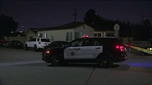 Officers investigate the scene of a police shooting in Long Beach on Jan. 20, 2018. (Credit: KTLA)
