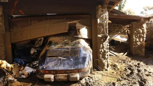 A Porsche pushed from the garage at a home on East Valley Road shows how far water rose above its banks. (Credit: Al Seib / Los Angeles Times)