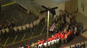 Dozens of law enforcement personnel honor Deputy Falce at a procession on Jan. 2, 2018. (Credit: KTLA)