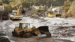 Crews continue to clear mud and debris from the 101 Freeway near Olive Mill Road. Officials said they hoped to have the freeway opened by next Monday. (Credit: Al Seib / Los Angeles Times)